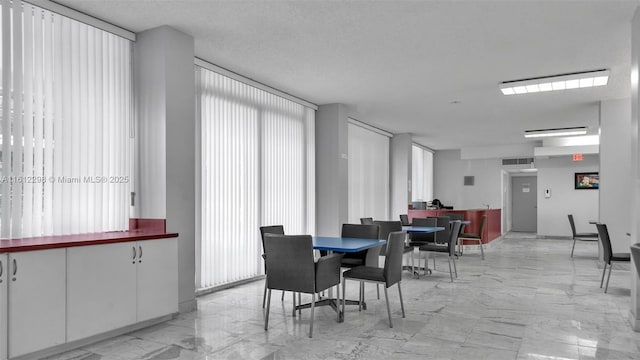 dining room with marble finish floor and visible vents