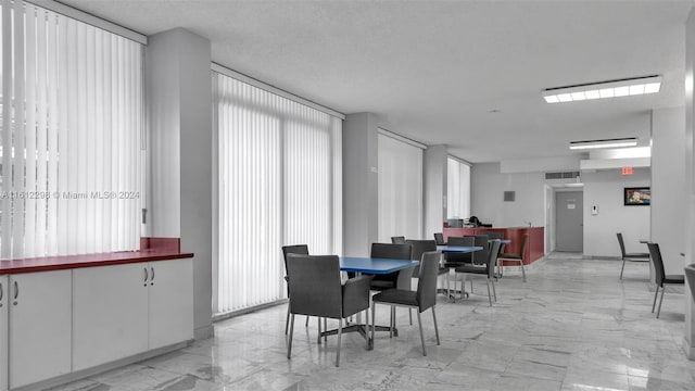 dining space featuring a textured ceiling