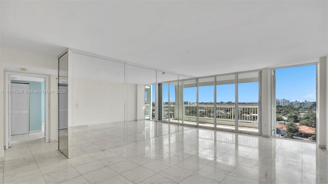 empty room with a wall of windows and a wealth of natural light
