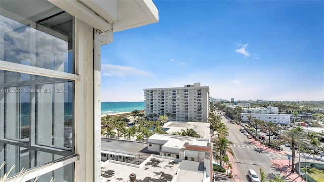 balcony with a water view and a beach view