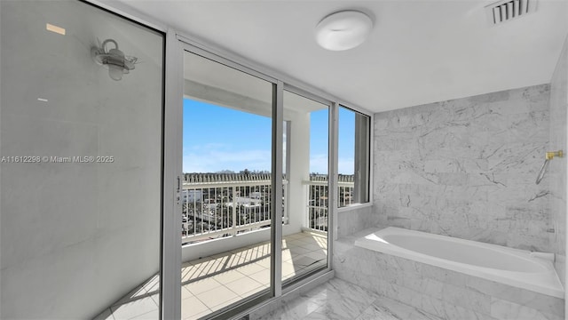 full bath featuring visible vents, a bath, and marble finish floor