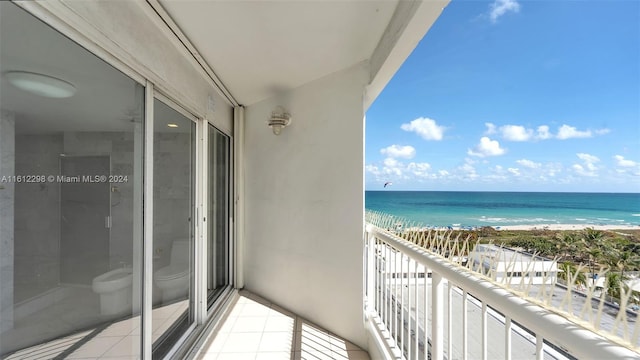 balcony with a water view and a beach view