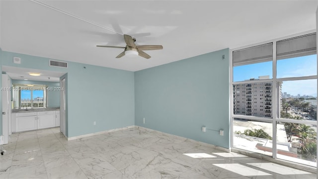 unfurnished room featuring ceiling fan