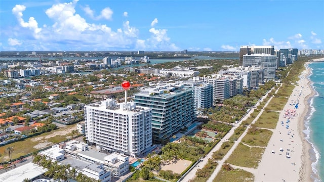 aerial view with a beach view, a water view, and a view of city