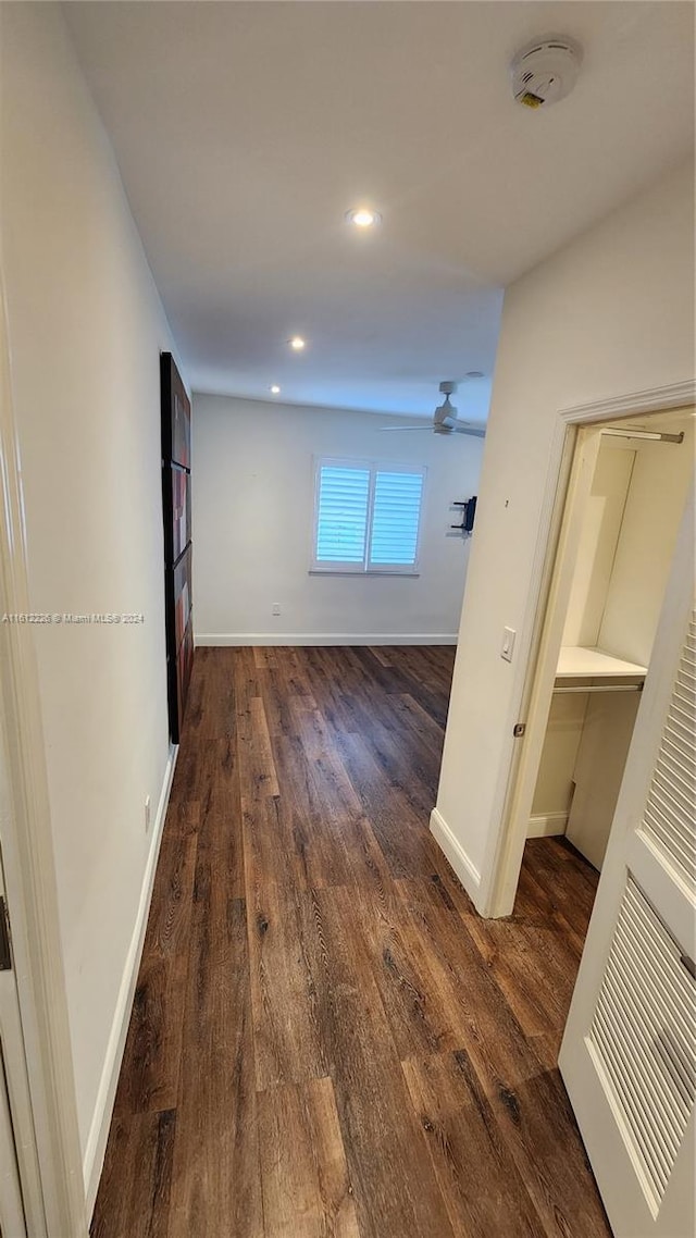 hallway with dark wood-type flooring