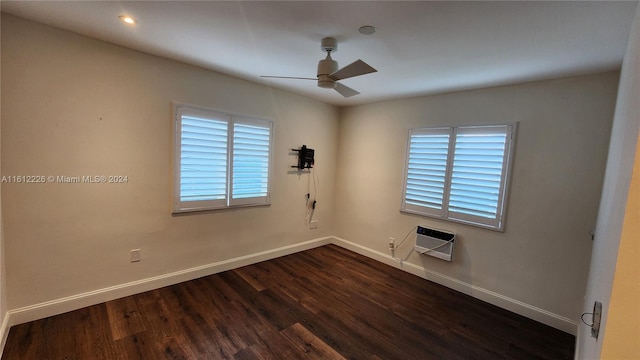 spare room with dark wood-type flooring and ceiling fan