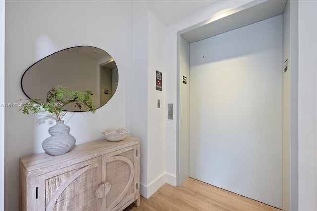 1010 Brickell Ave Unit 2201, Miami, FL 33131 - hallway featuring elevator, light wood finished floors, and baseboards