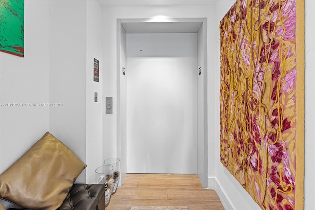 corridor with light hardwood / wood-style floors