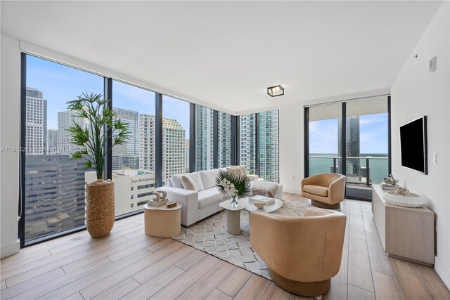 1010 Brickell Ave Unit 2201, Miami, FL 33131 - living room with expansive windows, light wood-style floors, and a skyline view