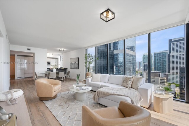 1010 Brickell Ave Unit 2201, Miami, FL 33131 - living area with wood finished floors, baseboards, a city view, and expansive windows