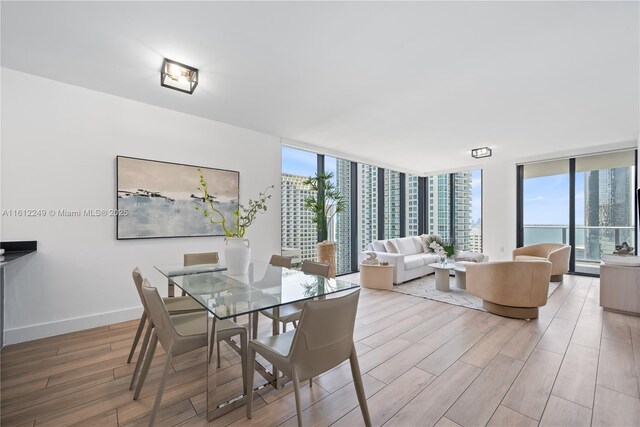 1010 Brickell Ave Unit 2201, Miami, FL 33131 - dining space with wood finished floors, floor to ceiling windows, and baseboards