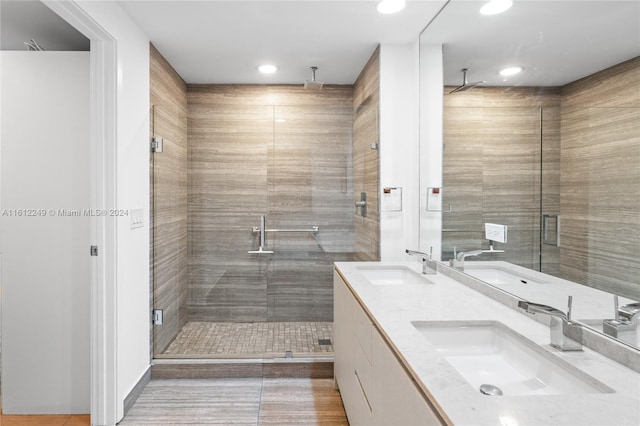 bathroom with tile patterned flooring, vanity, and a shower with shower door