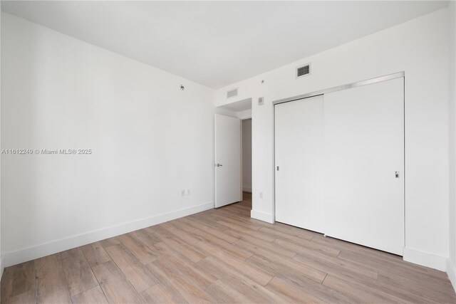 1010 Brickell Ave Unit 2201, Miami, FL 33131 - unfurnished bedroom with light wood-style flooring, a closet, and baseboards