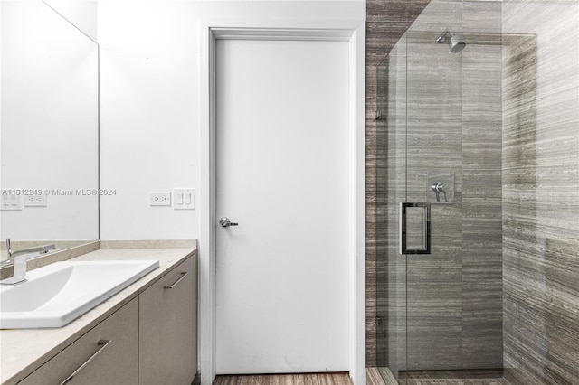 bathroom featuring vanity and an enclosed shower