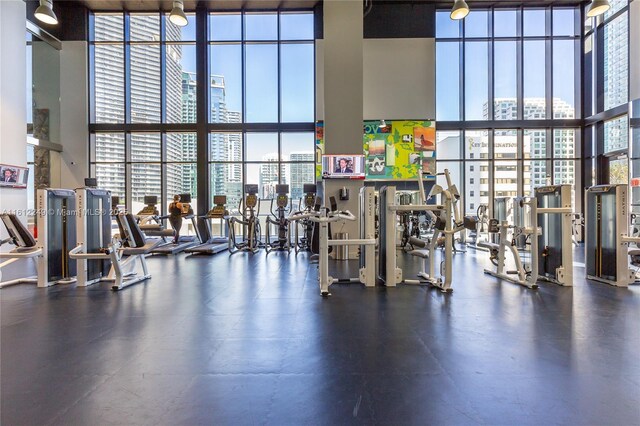 1010 Brickell Ave Unit 2201, Miami, FL 33131 - gym featuring expansive windows, a towering ceiling, and a city view
