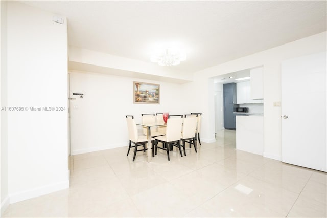 dining area featuring a notable chandelier and light tile floors