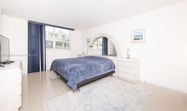 bedroom with light tile floors