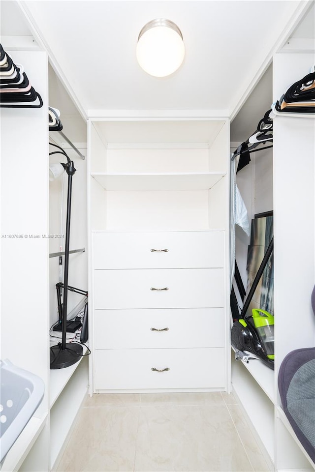 walk in closet featuring light tile floors