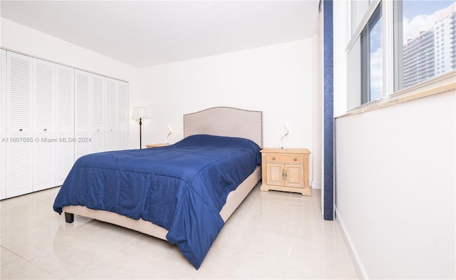 tiled bedroom featuring a closet