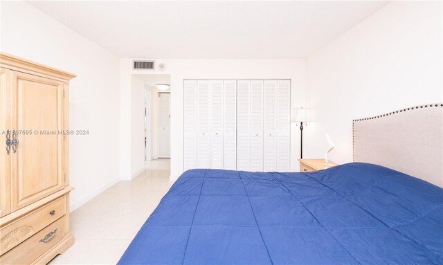 unfurnished bedroom with a closet and light tile flooring