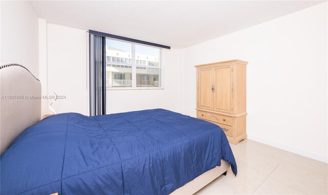 tiled bedroom featuring expansive windows