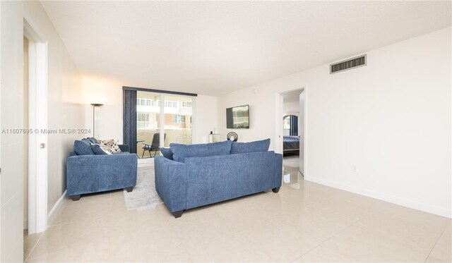 living room featuring light tile floors