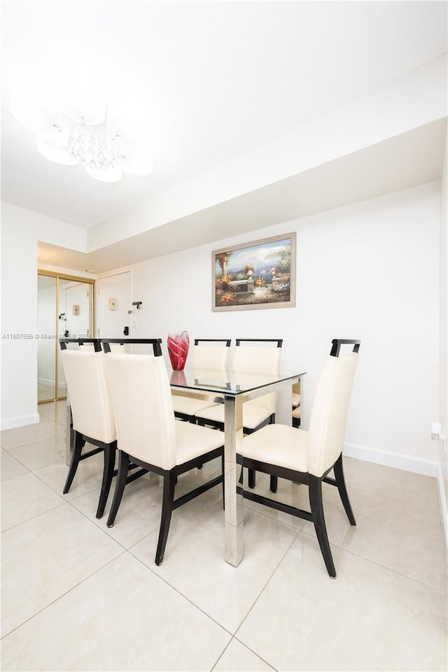 dining space featuring light tile floors