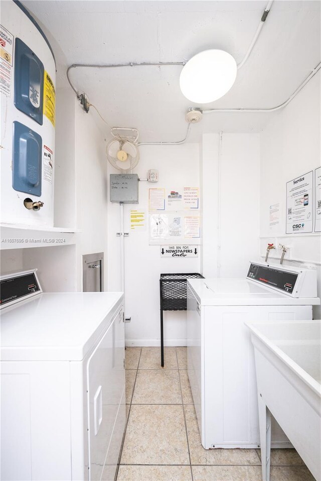 laundry area featuring washer and dryer, sink, hookup for a washing machine, and light tile floors