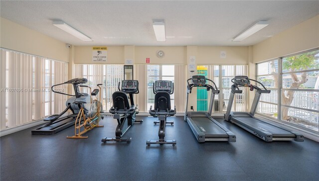 exercise room with a textured ceiling