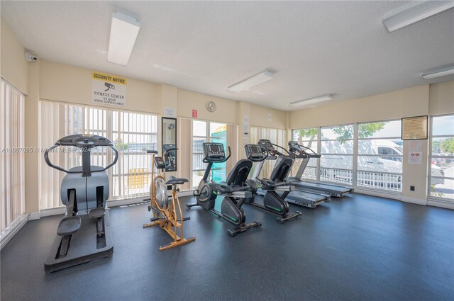 workout area featuring a textured ceiling and plenty of natural light