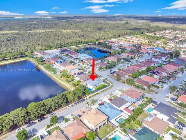 birds eye view of property with a water view