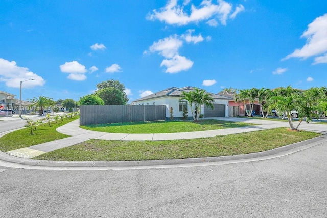 view of front of property featuring a garage and a front lawn