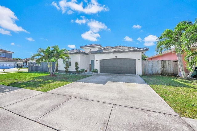 mediterranean / spanish home with a garage and a front lawn