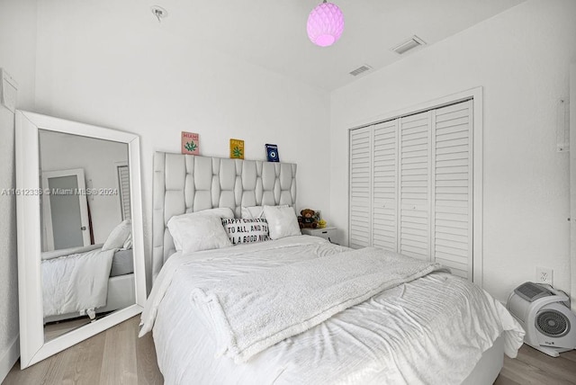 bedroom featuring a closet and light wood-type flooring