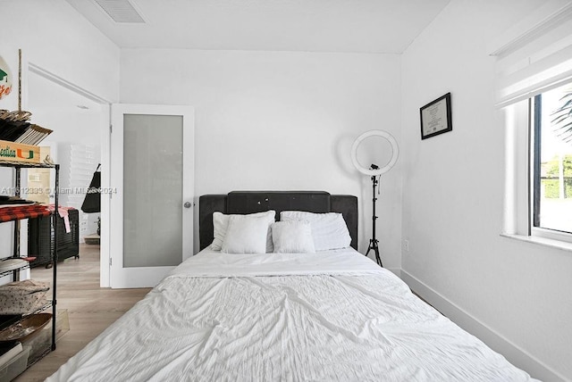 bedroom with light hardwood / wood-style flooring