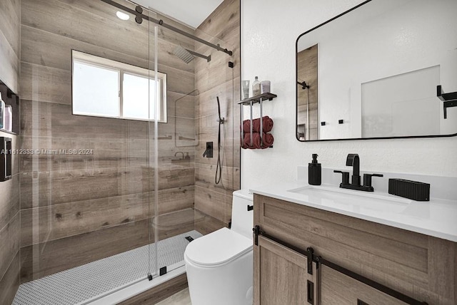 bathroom featuring hardwood / wood-style floors, vanity, toilet, and a shower with door