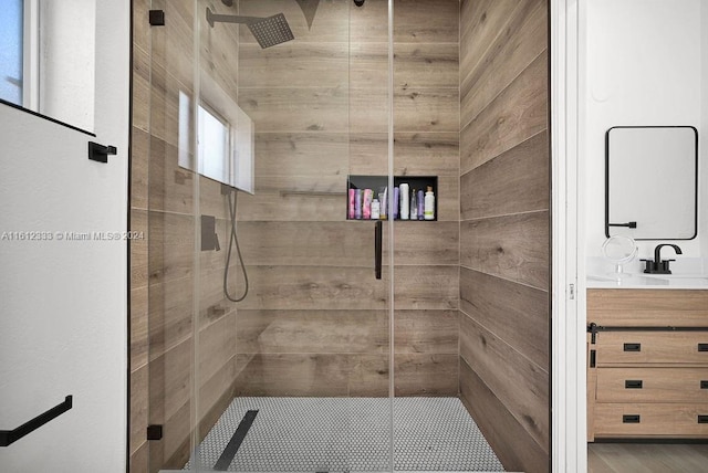 bathroom with vanity and a shower with door