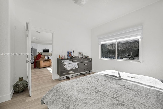 bedroom with light wood-type flooring