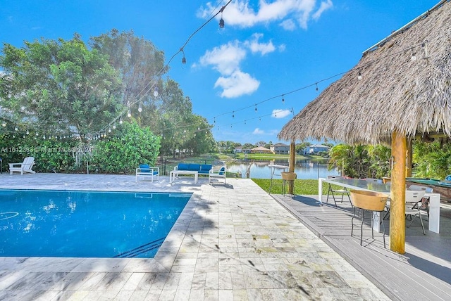 view of swimming pool featuring a water view