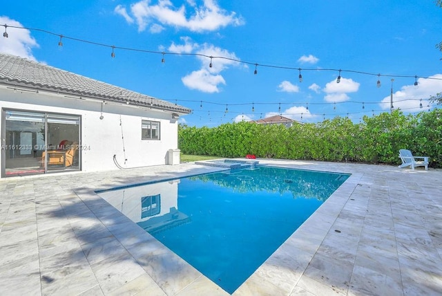 view of swimming pool with a patio