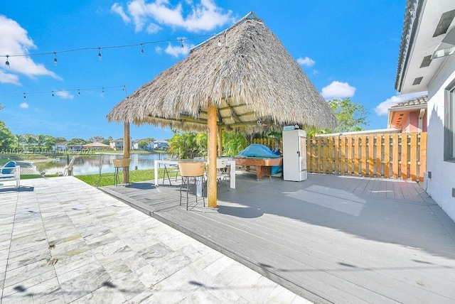 view of patio / terrace with a gazebo and a deck with water view