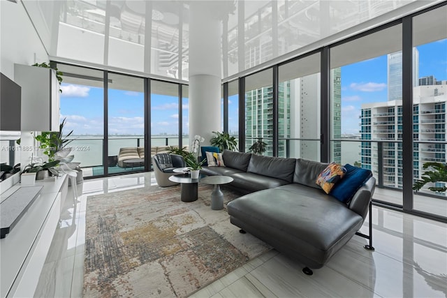 tiled living room featuring a water view