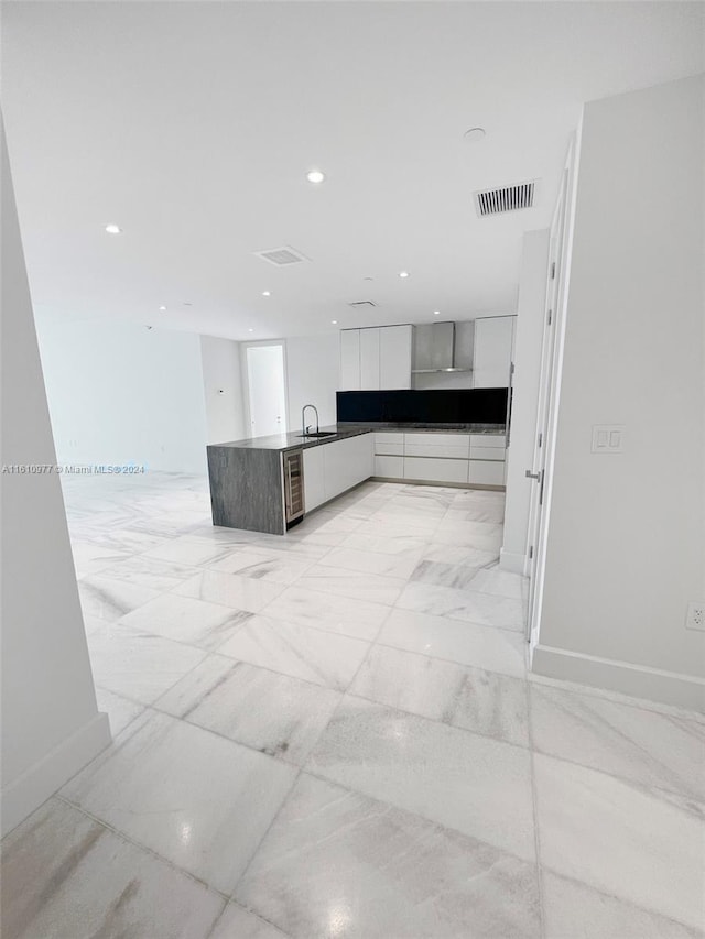 kitchen with wine cooler, white cabinets, and light tile flooring