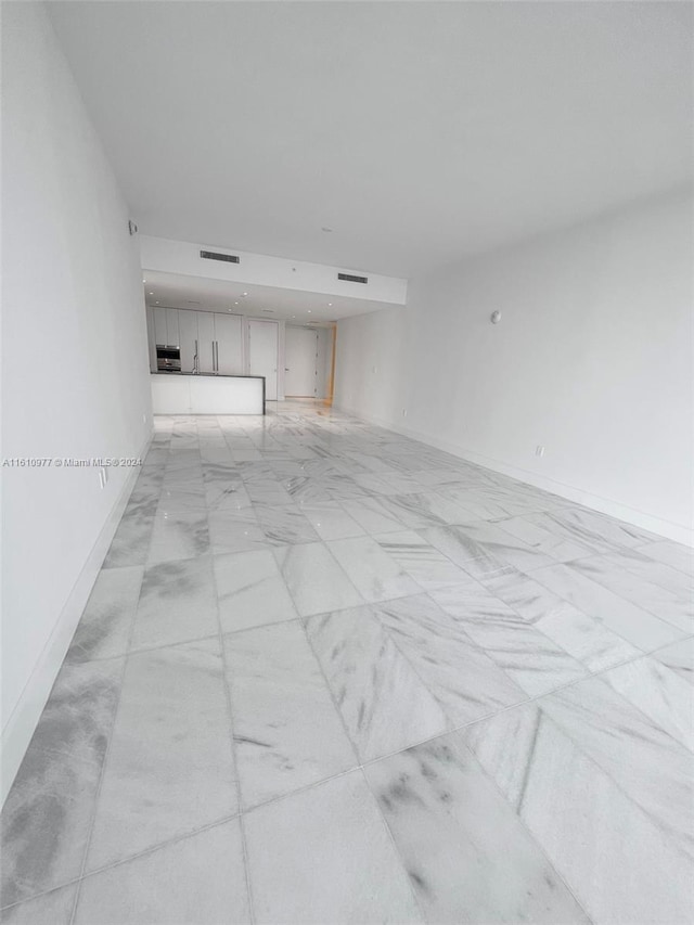 unfurnished living room with light tile floors