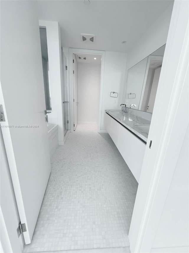 bathroom with vanity and tile floors