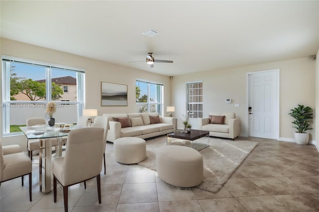 tiled living room with ceiling fan and plenty of natural light