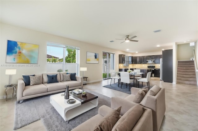 living room with ceiling fan and light tile patterned floors