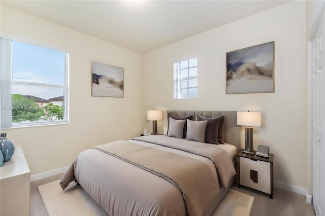 bedroom featuring light colored carpet