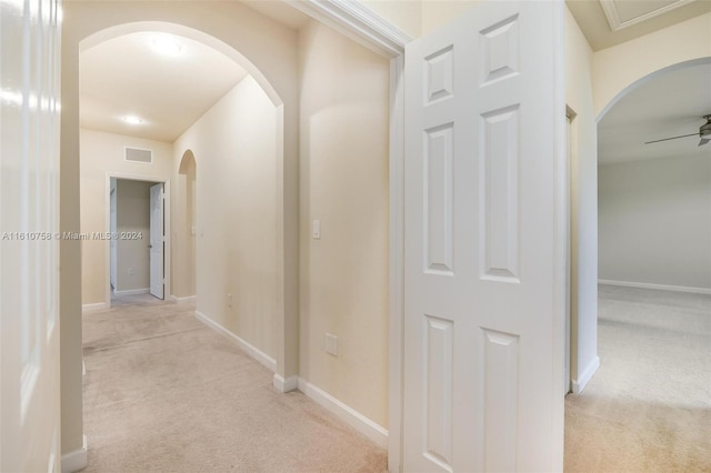 hall featuring light colored carpet