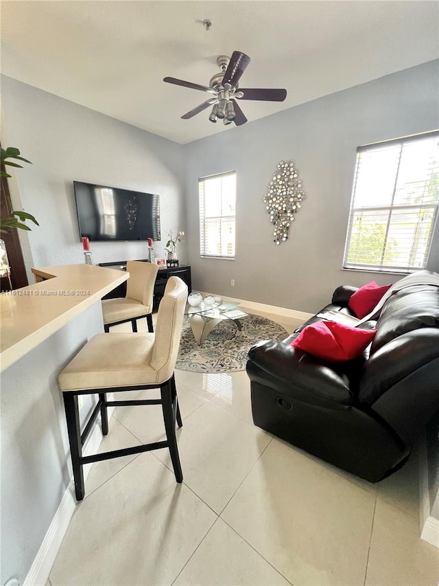 living room featuring a wealth of natural light, ceiling fan, and light tile floors